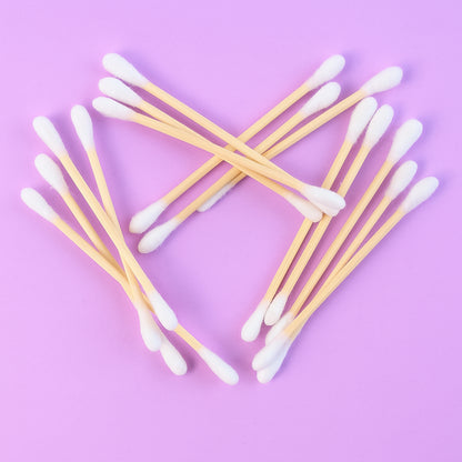 Wukusy eco-friendly wooden cotton ear buds in a transparent plastic packaging, 100 pcs, with wooden and cotton tips.