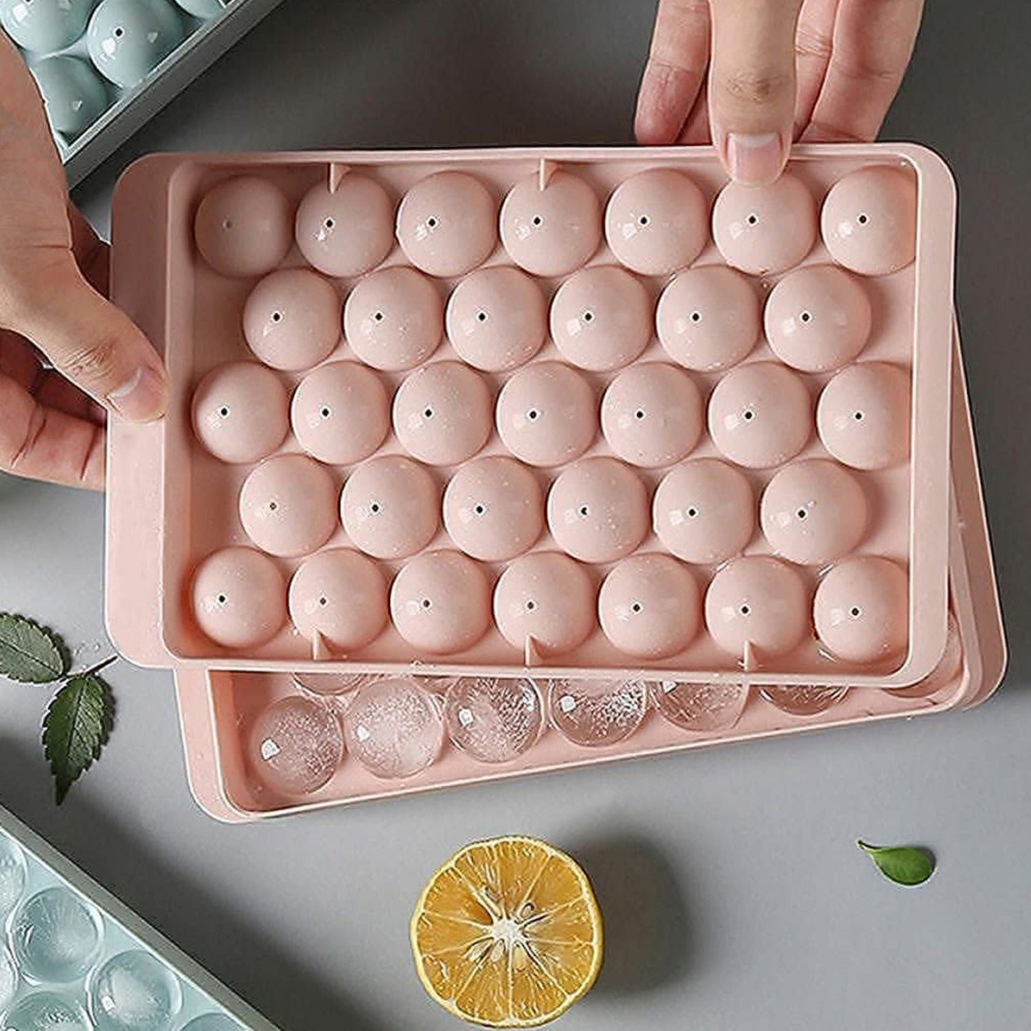 Wukusy plastic round reusable ice cube mold with 33 cavities, also used for lollipop and candy making, shown in image.