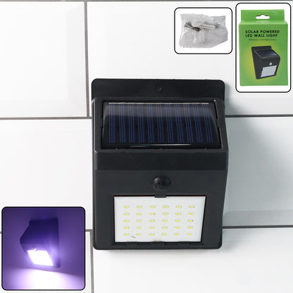 Wukusy solar powered LED wall light mounted on garden wall, illuminating outdoor space with eco-friendly lighting.