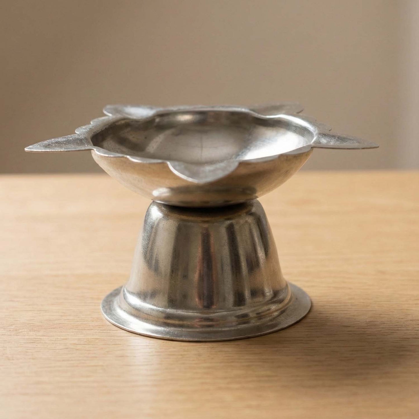Large stainless steel sunflower design diya stand by Wukusy, decorative holder for diya lamps with detailed sunflower pattern