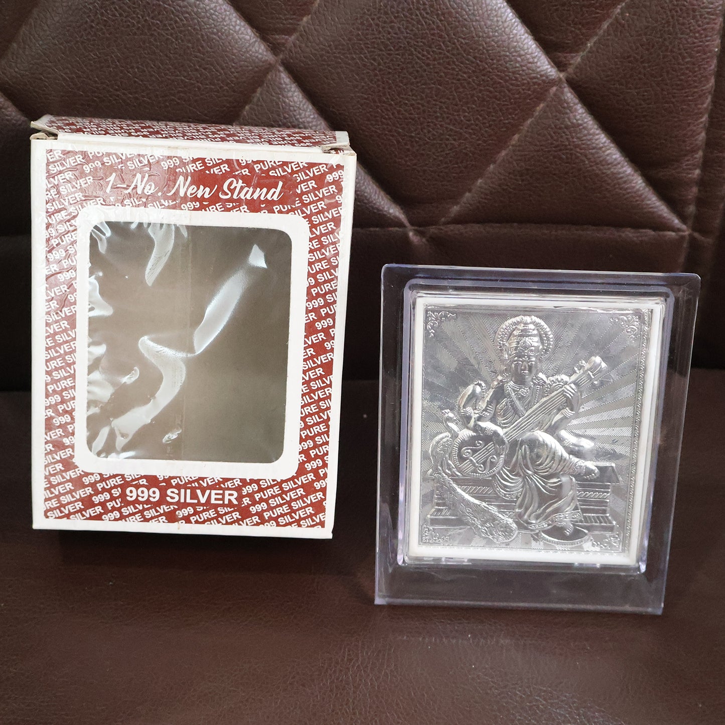 Elegant silver Saraswati Maa photo frame with stand, decorative home decor piece by Wukusy featuring intricate design.