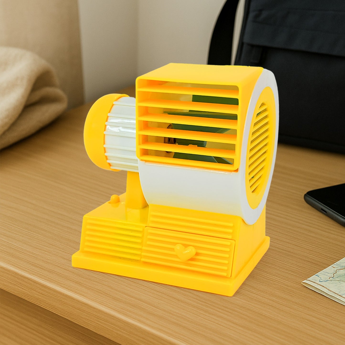 Wukusy Mini Dual-blade Portable USB table fan on office desk, compact and lightweight for personal cooling.