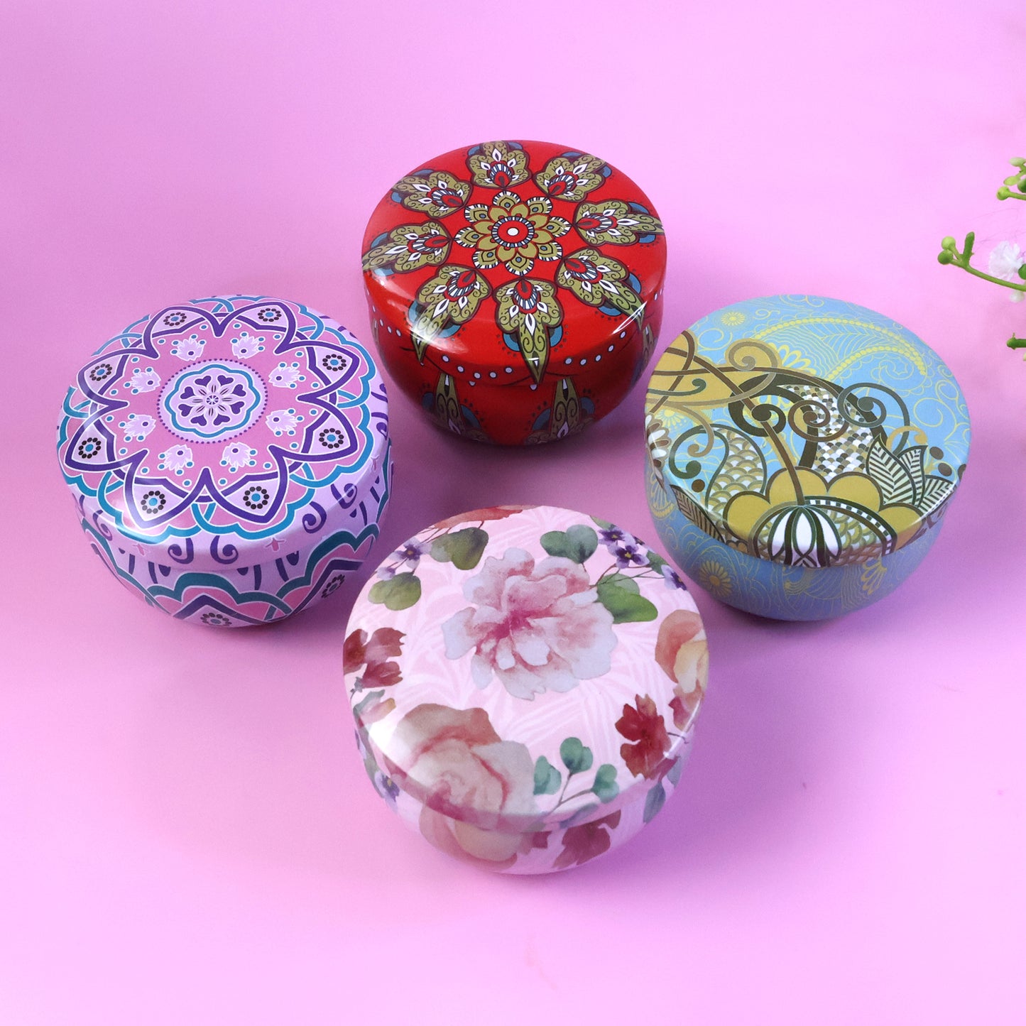 Set of four Wukusy decorative metal candle containers with intricate mandala prints, ideal for enhancing home decor.
