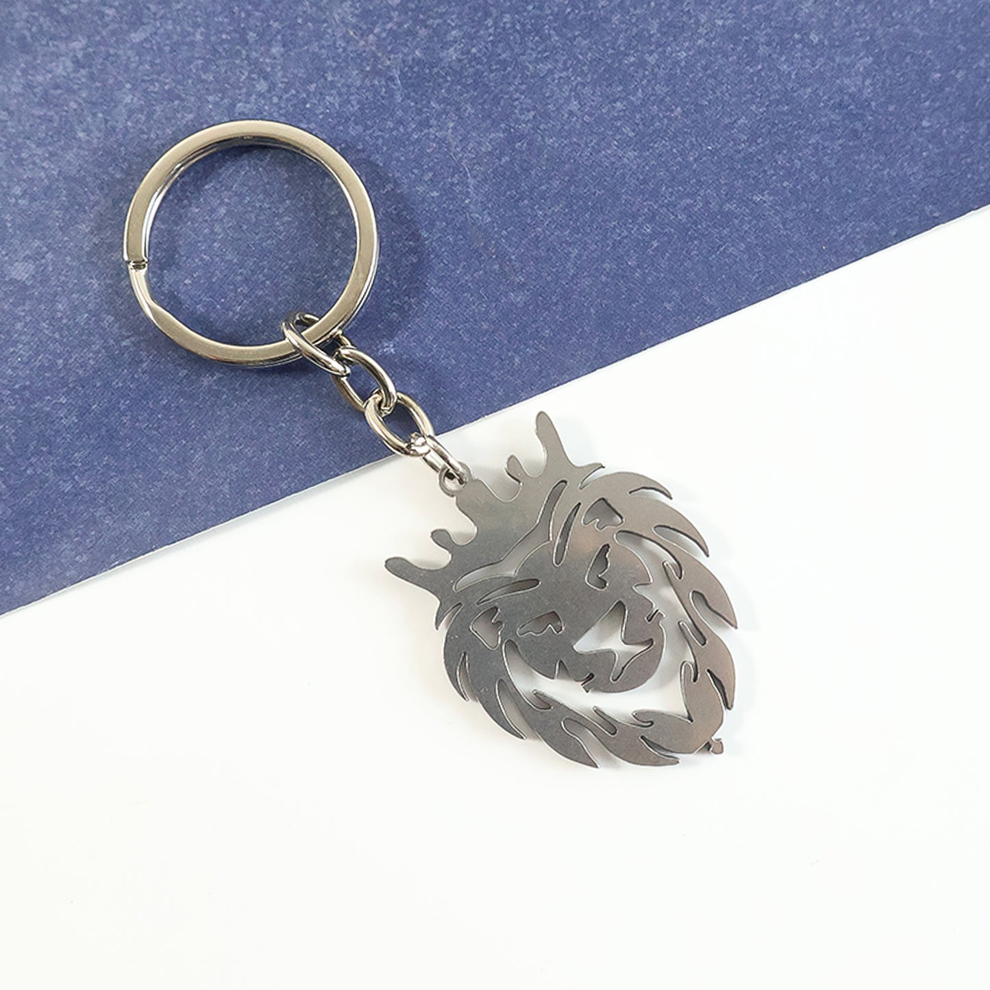 Metal lion head keychain by Wukusy featuring a detailed lion's face and sleek metal finish, perfect for keys or accessories.