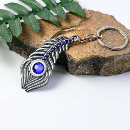 Wukusy elegant metal peacock feather keychain showcasing detailed feather design on a keyring.