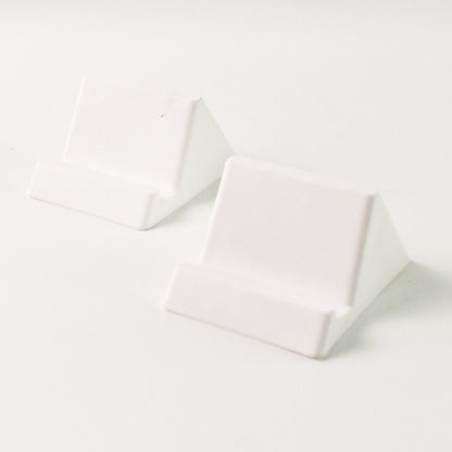 Two Wukusy compact plastic mobile phone holder stands in mixed colors, designed for hands-free support and easy viewing.