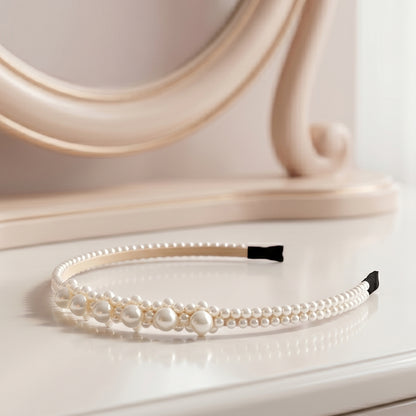 Wukusy pearl beaded designer hairband for women, stylish headband with pearl accents, shown on a model.