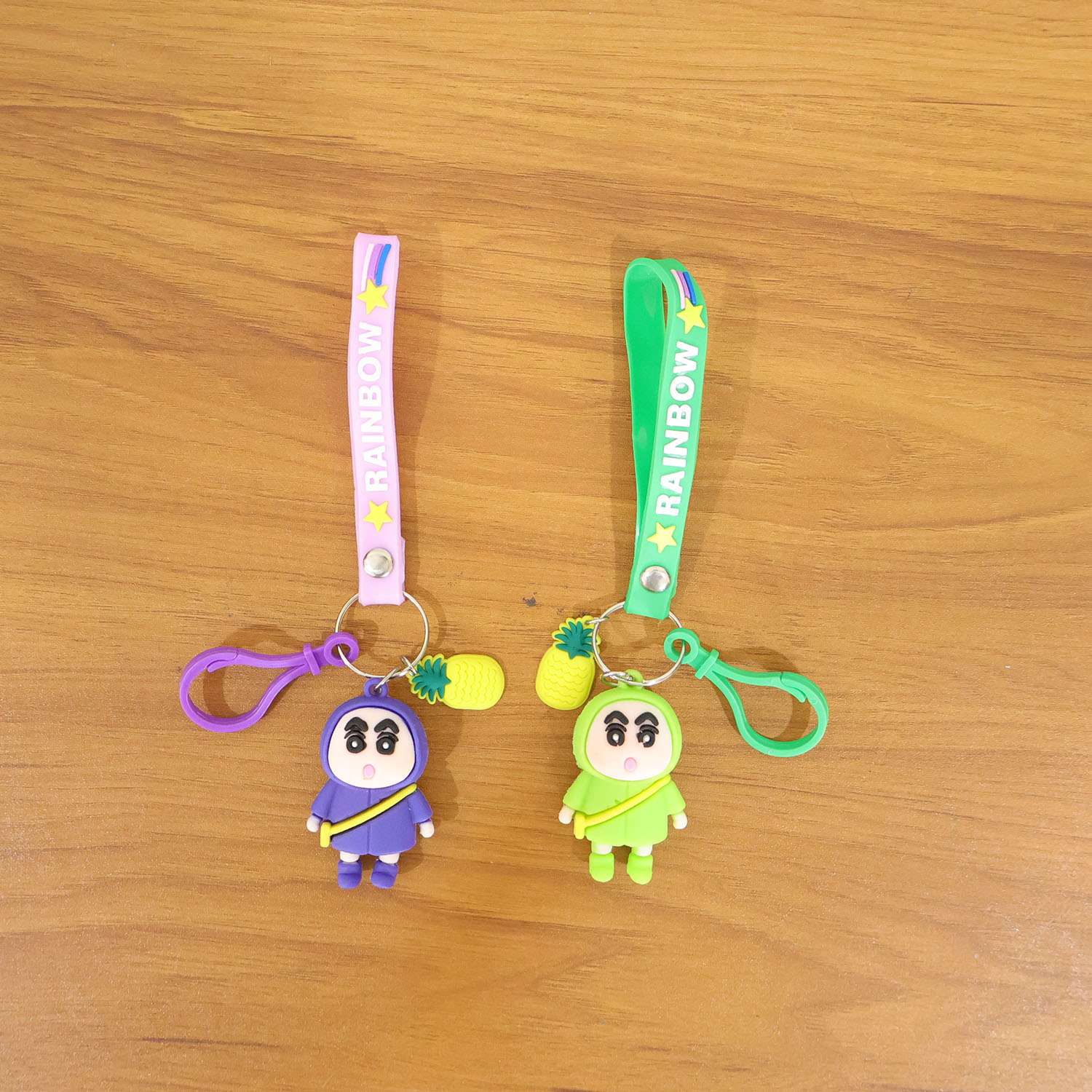 Cute cartoon doll keychain with pineapple charm and strap, featuring vibrant colors and playful design by Wukusy.