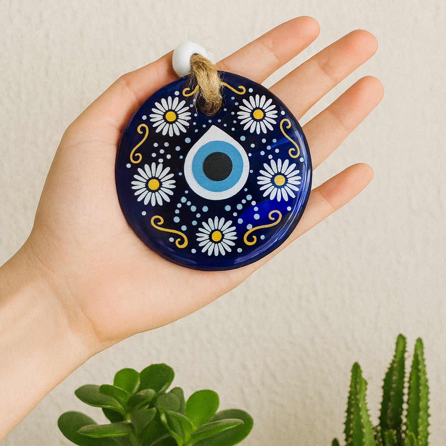 Decorative evil eye wall hanging with beads and wind chime, Nazar protector charm by Wukusy, designed to ward off negative energy.