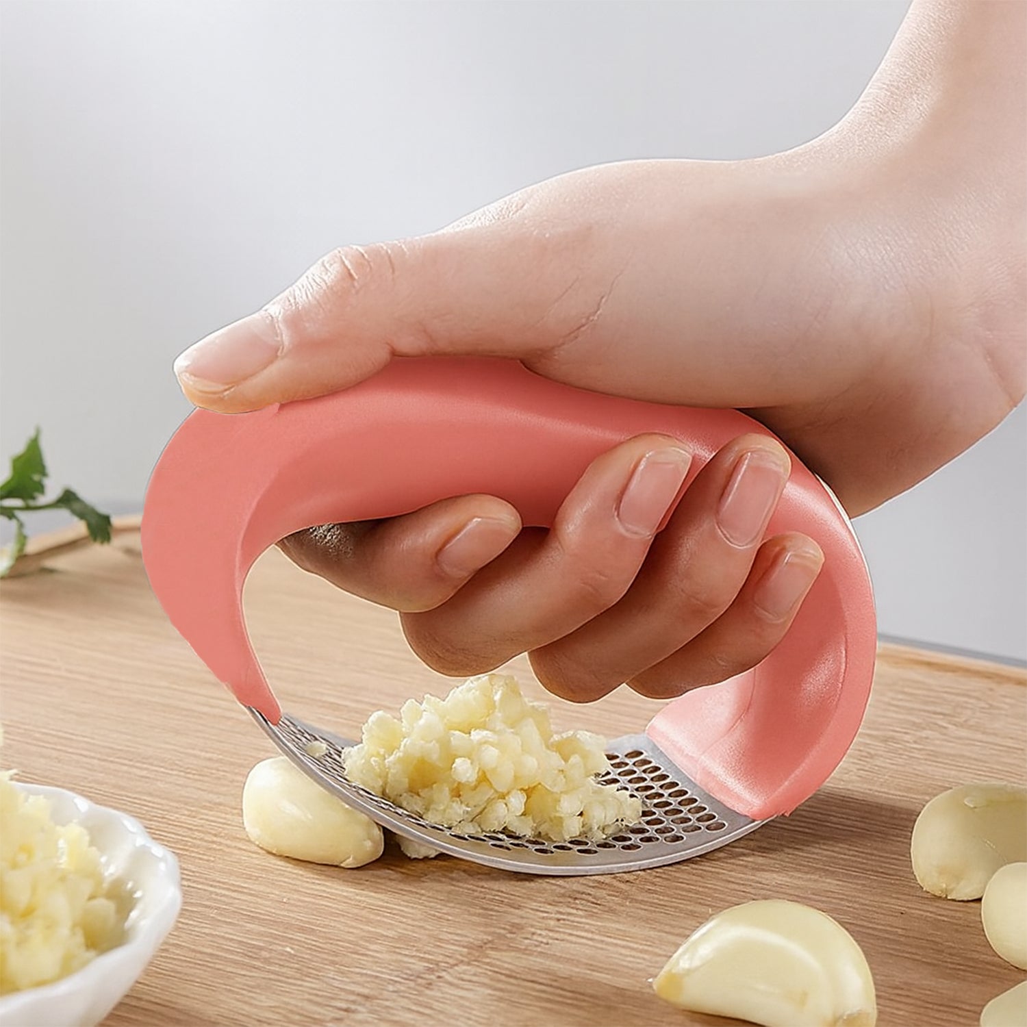 Wukusy Supermom Premium Curve Garlic Press Crusher for kitchen use, stainless steel design with ergonomic handle.
