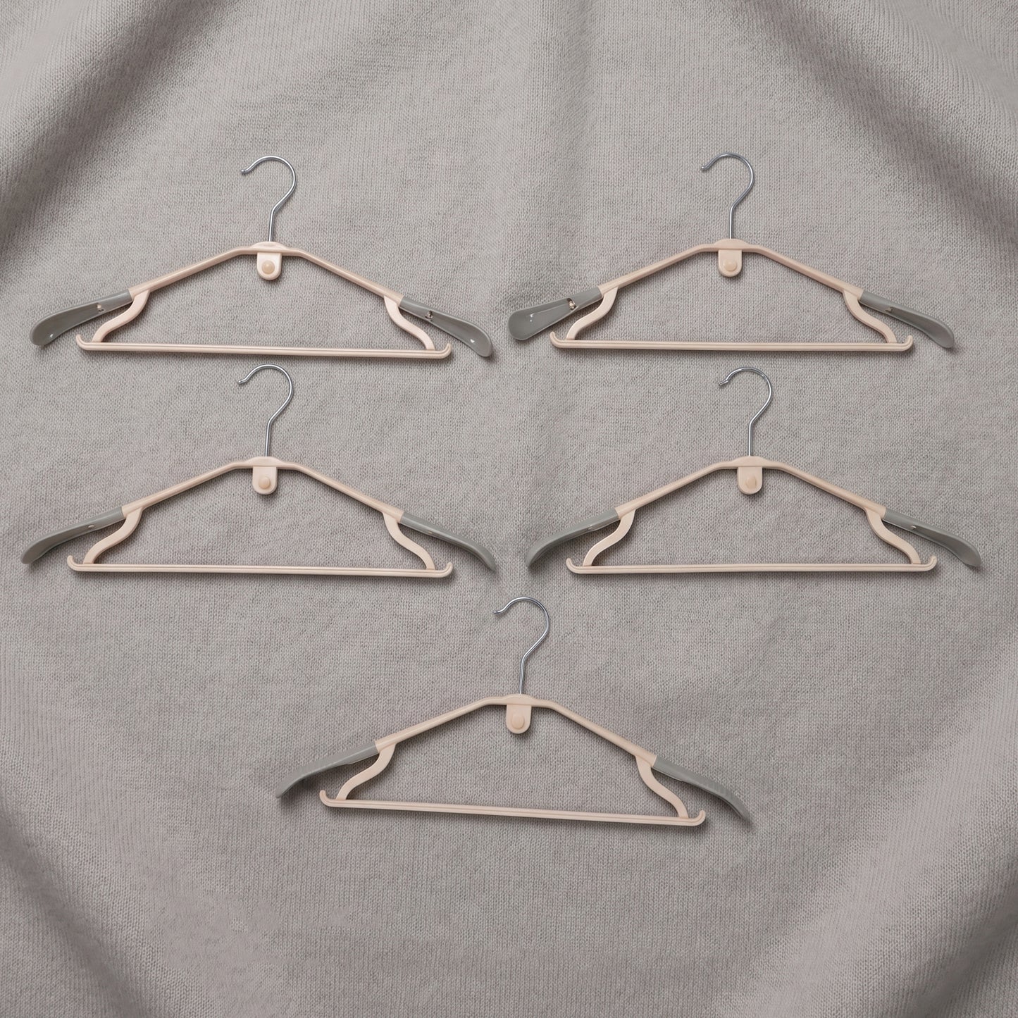 Set of five durable plastic clothes hangers from Wukusy, featuring smooth edges and sturdy design for clothing organization.