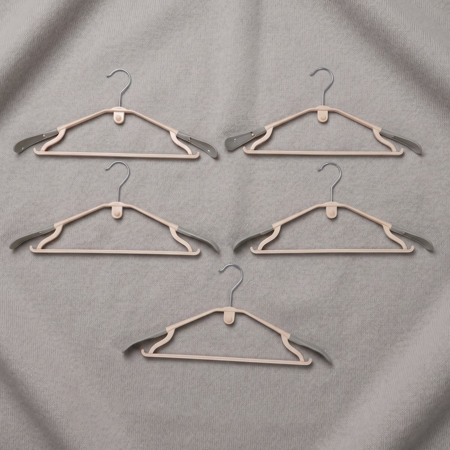 Set of five durable plastic clothes hangers from Wukusy, featuring smooth edges and sturdy design for clothing organization.