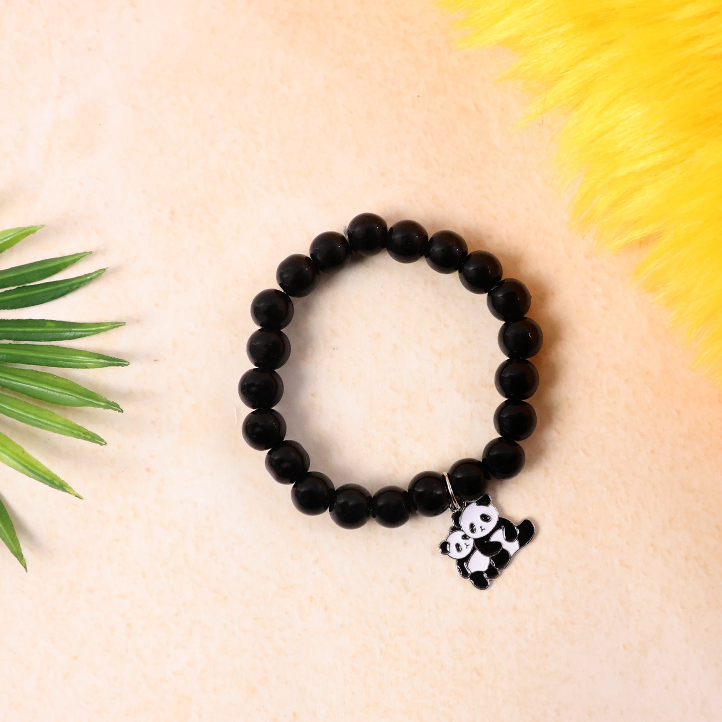 Black beaded stretch bracelet with cute panda charm from Wukusy, featuring a stylish and playful accessory design.
