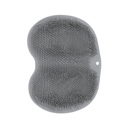 Wukusy silicone bathroom foot cleaning scrubber mat on a bathroom floor, 27x20 cm, with textured surface for foot scrubbing.