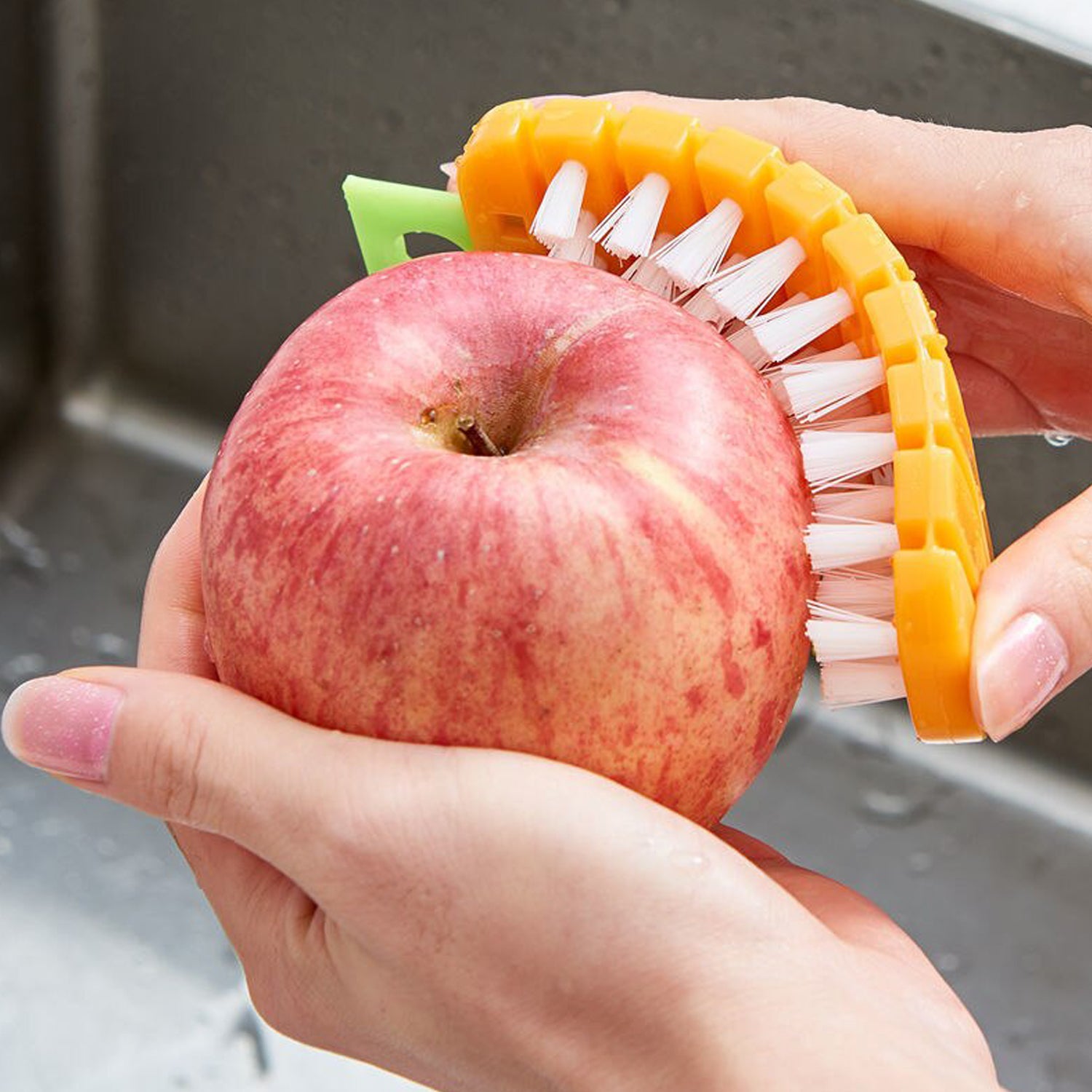 Wukusy carrot-shaped vegetable scrubber and fruit brush for cleaning potatoes, carrots, and other vegetables in the kitchen.