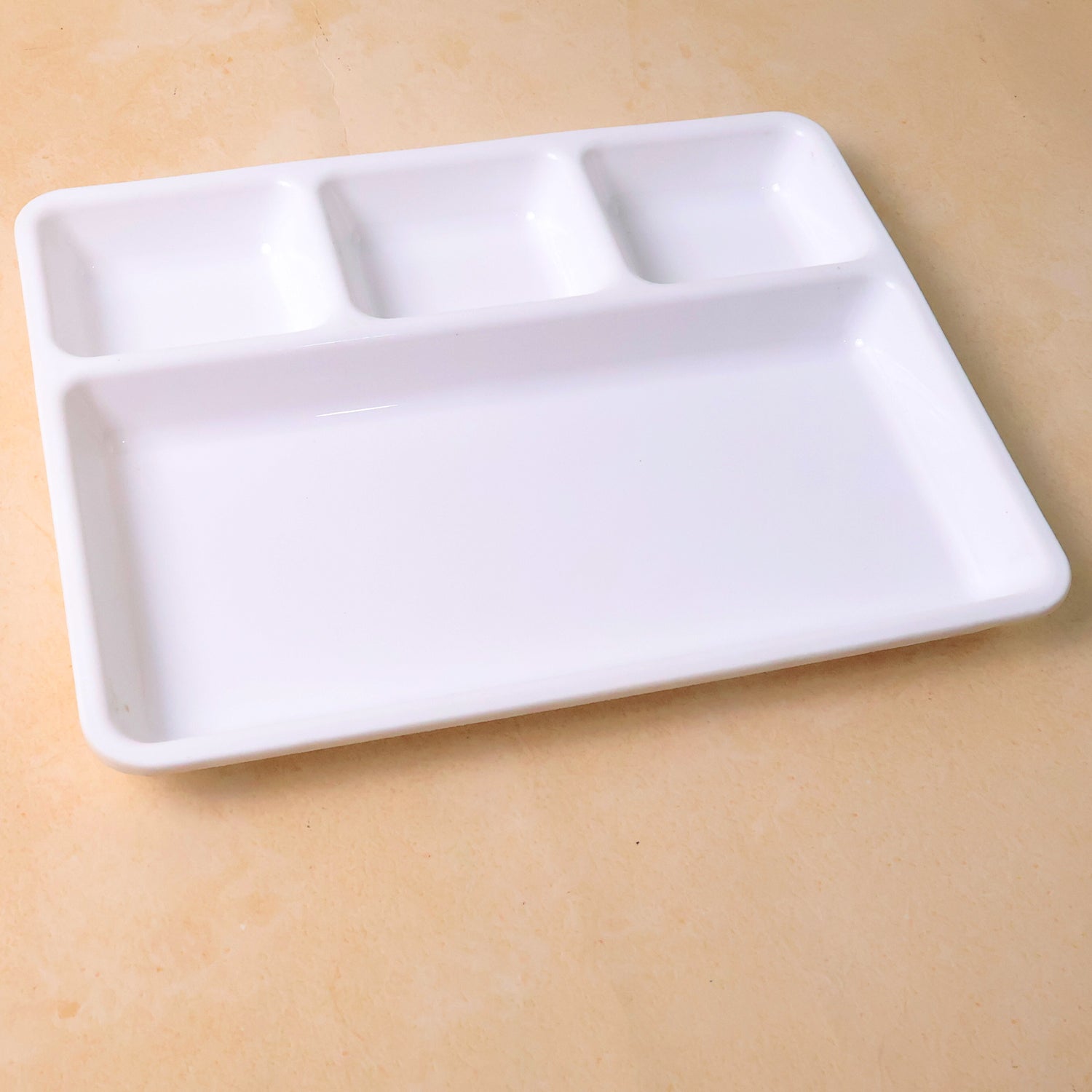 White plastic 4-compartment rectangular meal serving tray from Wukusy, ideal for home and kitchen use.