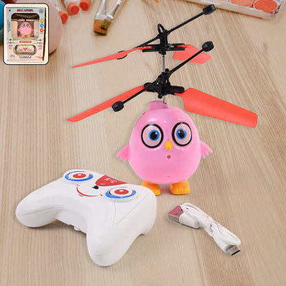 Pink owl-shaped flying RC toy with LED lights from Wukusy, featuring remote control and vibrant design in a set.