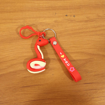 Cute cartoon snake keychain by Wukusy featuring a colorful, playful snake design on a metal keyring.