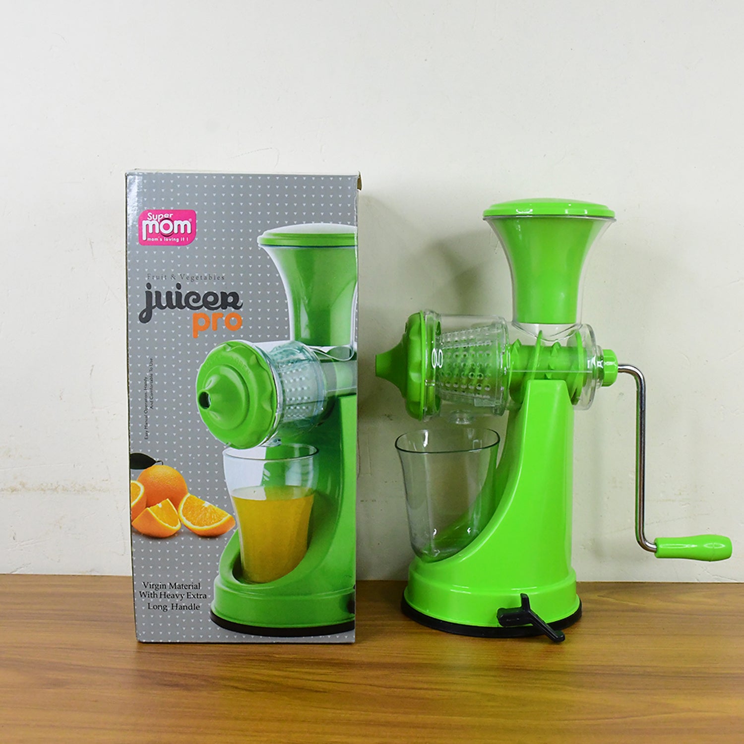Wukusy Supermom manual hand press fruit and vegetable juicer on kitchen countertop with juicing components visible