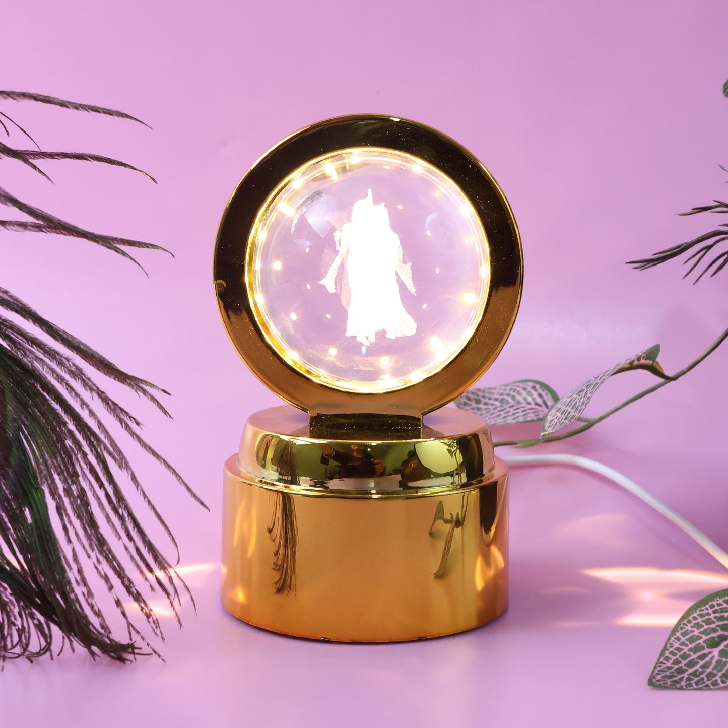 Wukusy Radhe Krishna crystal ball night light on office desk, illuminated crystal sphere with intricate Krishna design.