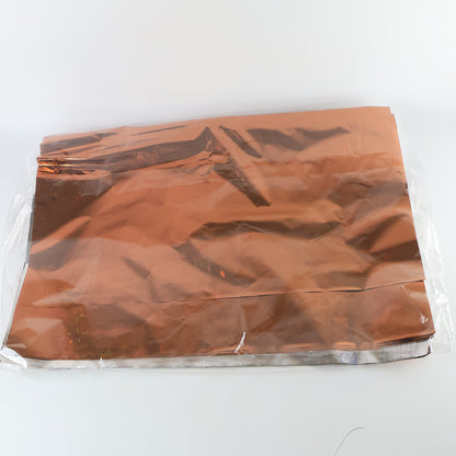 Assorted metallic gift wrapping paper sheets in mix colors, 70x50 cm, from Wukusy, displayed in a stack.