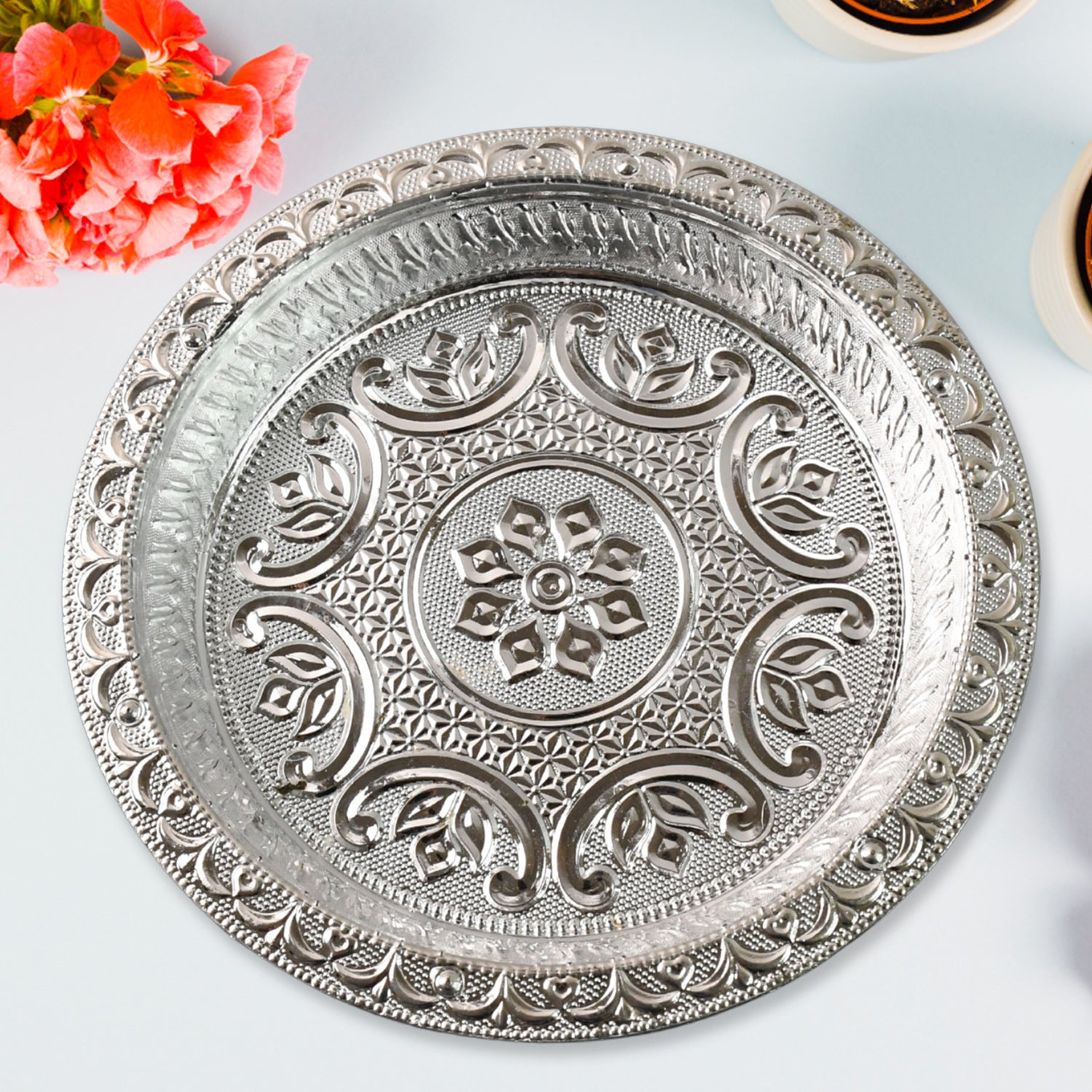 Traditional silver finish plastic Pooja Thali by Wukusy, featuring a decorative design for religious ceremonies and home worship.