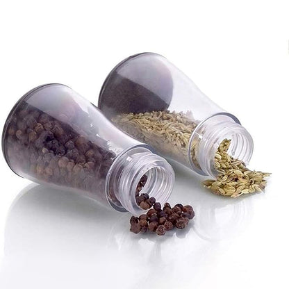 Six plastic spice jars with clear lids arranged on a stand, perfect for organizing spices in a home kitchen.