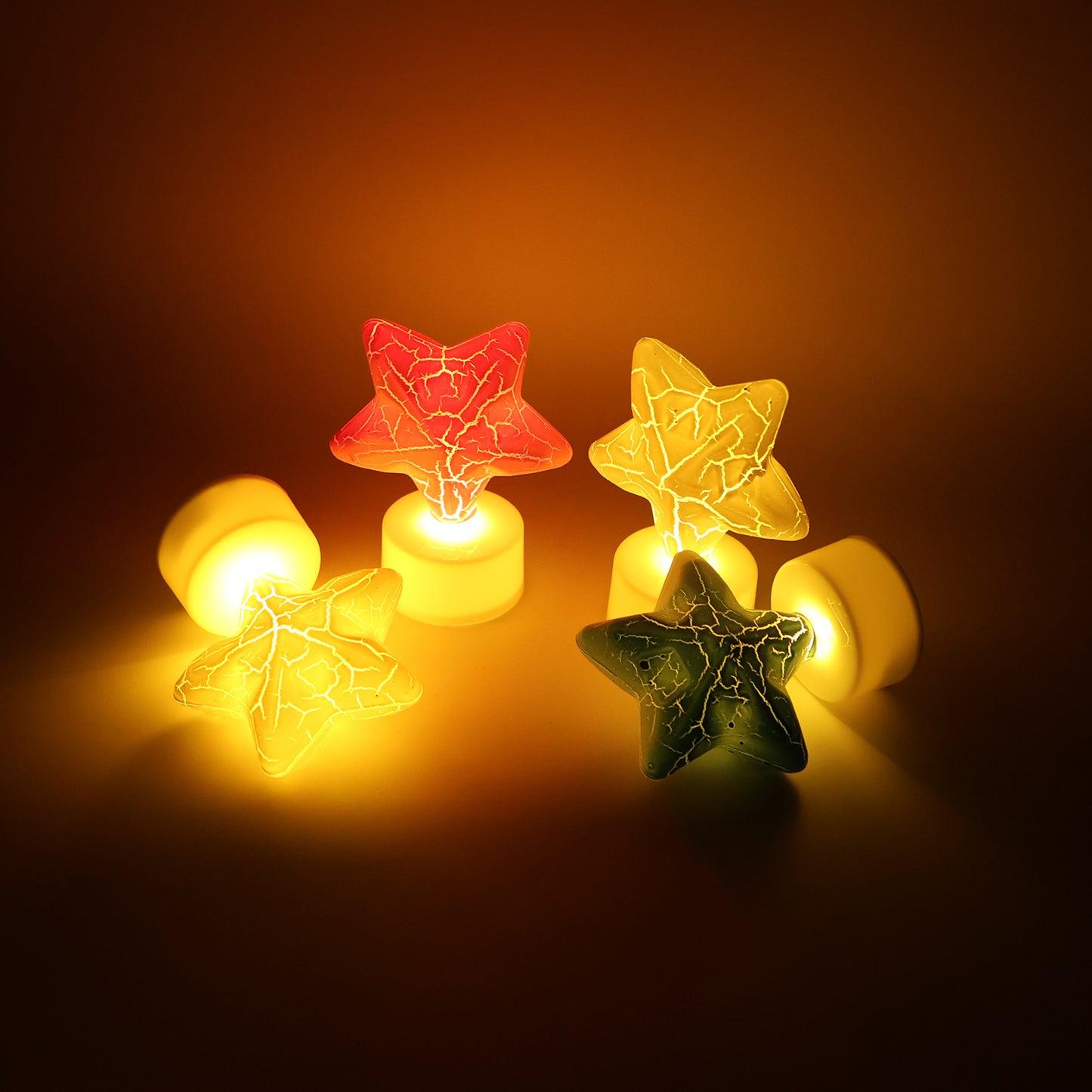 Set of four star-shaped decorative LED tealight candles by Wukusy for home decor, glowing softly in a cozy setting.