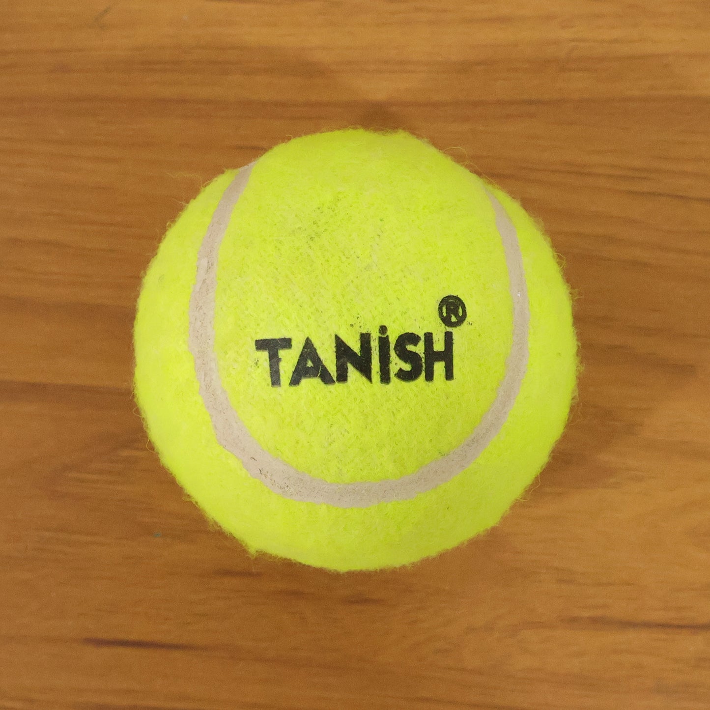 Wukusy premium tennis ball, single yellow rubber ball with black Wukusy logo for tennis play and practice.