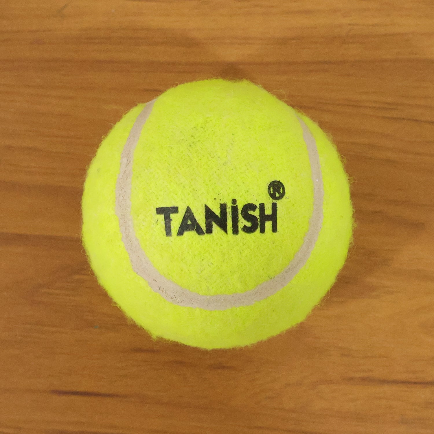 Wukusy premium tennis ball, single yellow rubber ball with black Wukusy logo for tennis play and practice.