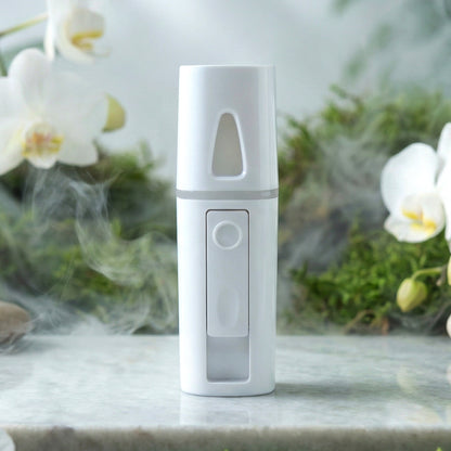 Wukusy portable humidifier nano mist sprayer showing compact device emitting a fine mist for room humidity.
