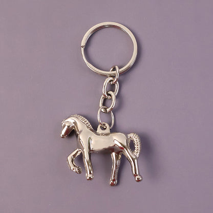 Shiny metallic horse-shaped keychain by Wukusy with a sleek finish, hanging from a keyring.