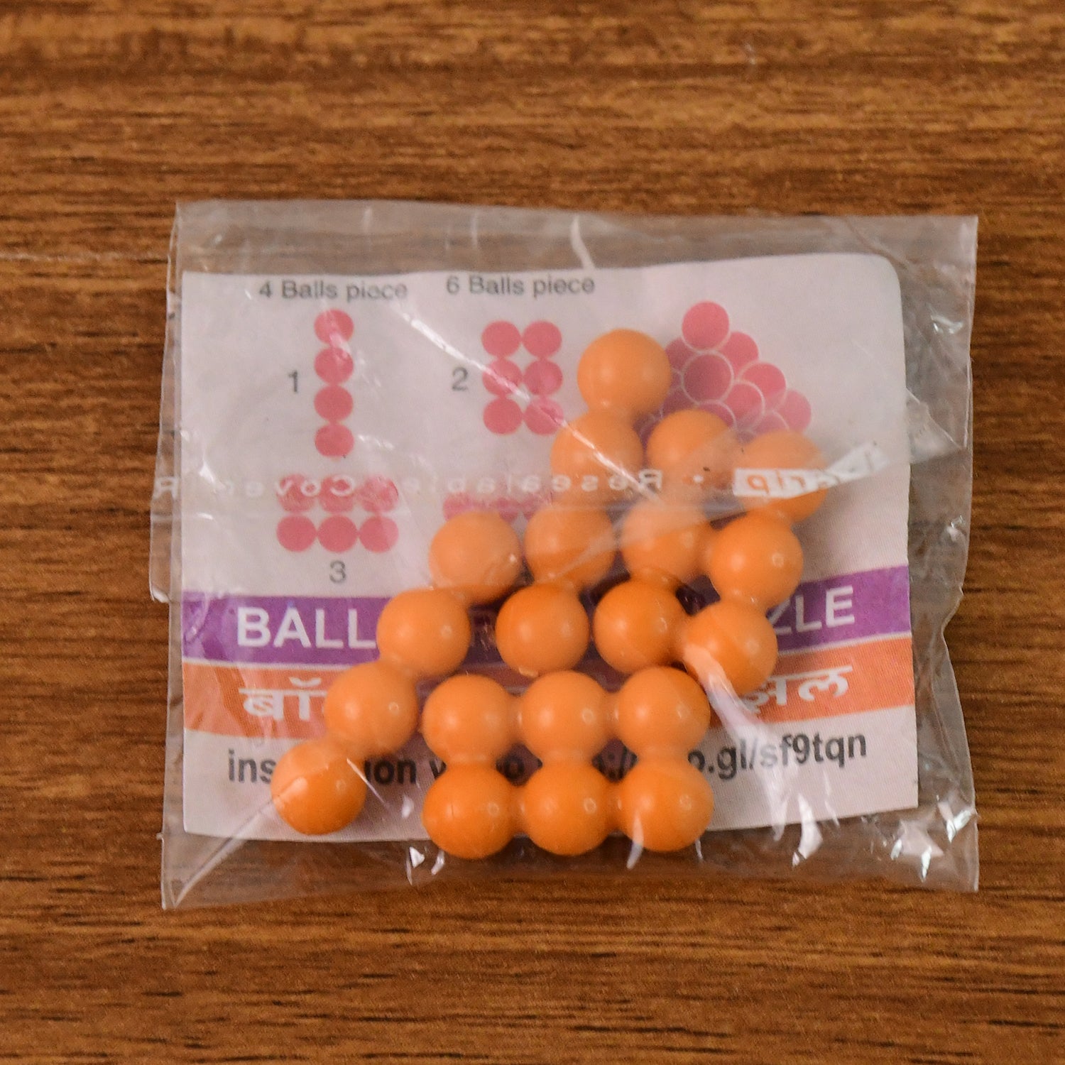 Wukusy ball pyramid 3D puzzle toy with colorful interconnected spheres, designed as a brain teaser and educational building toy.