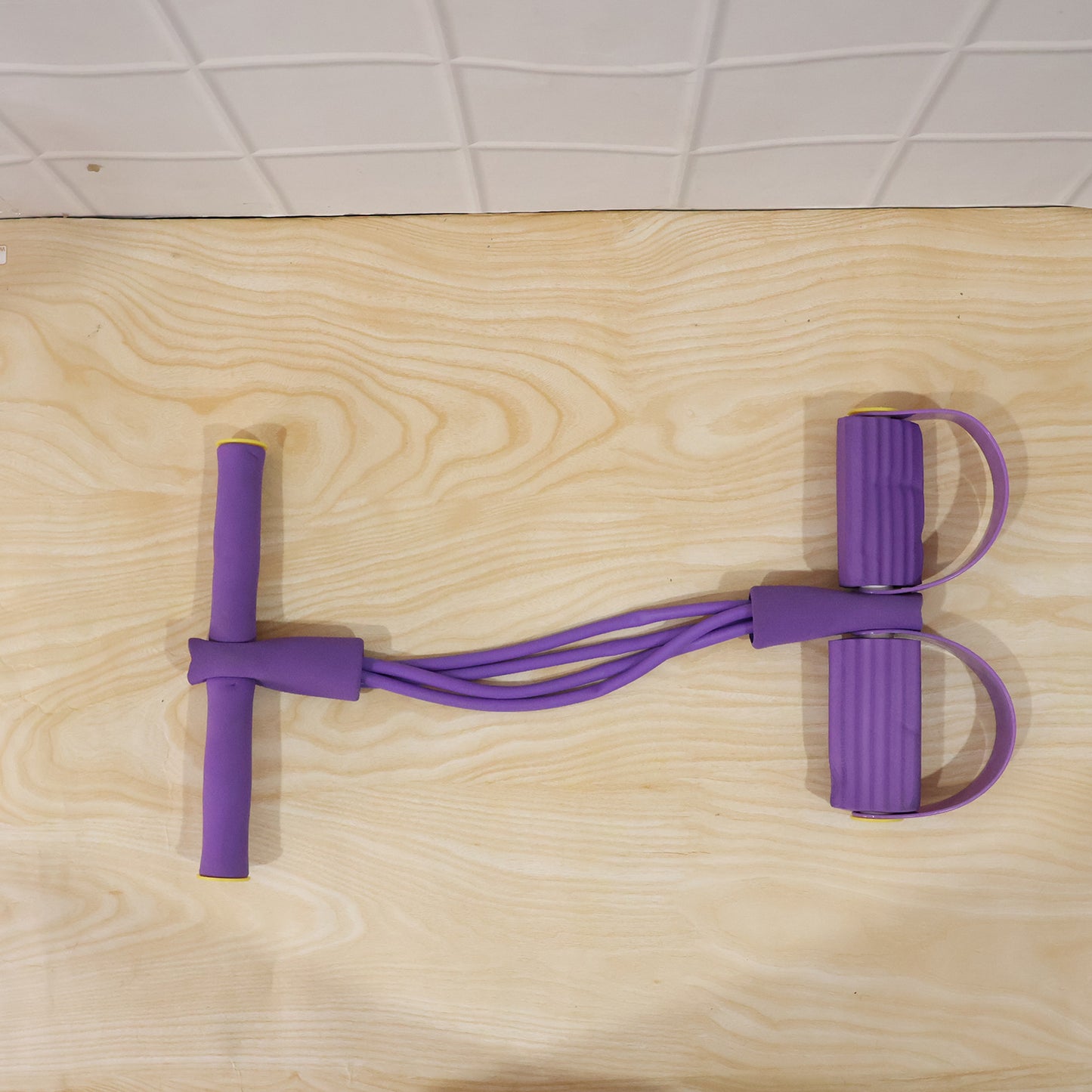 Wukusy portable resistance exerciser with pull rope and foot pedal support, ideal for strength training and workouts.