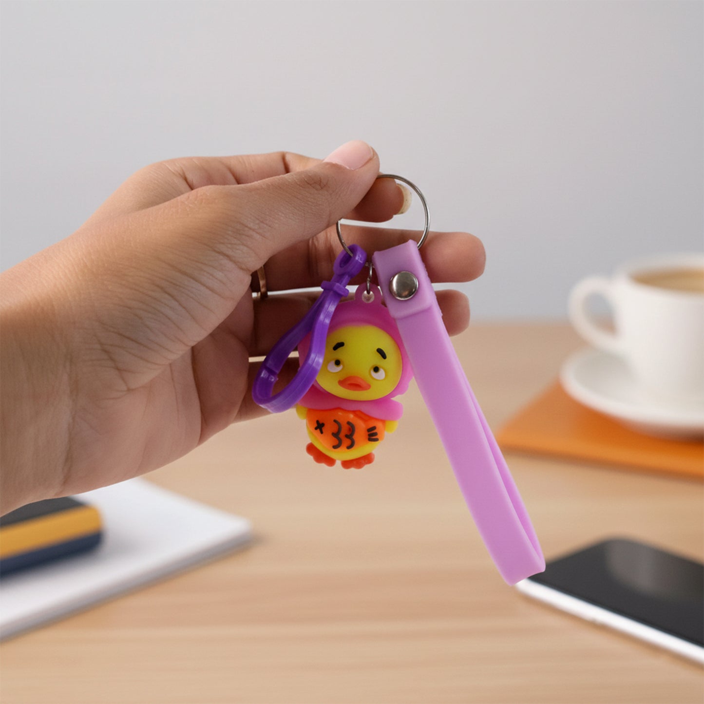 Cute cartoon duck keychain by Wukusy featuring a bright yellow duck with a small loop for keys or bags.