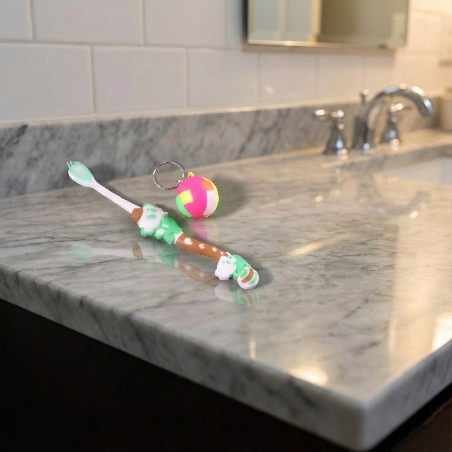 Kids toothbrush and ball keychain toy set by Wukusy, featuring colorful toothbrush and playful ball keychain for children.