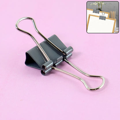 Wukusy heavy-duty foldback binder clip holding papers, sturdy metal clip for home improvement and organization tasks.