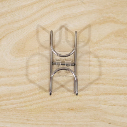 Transparent double loop adhesive wall hook by Wukusy, showing a clear plastic hook with dual loops attached to a wall.