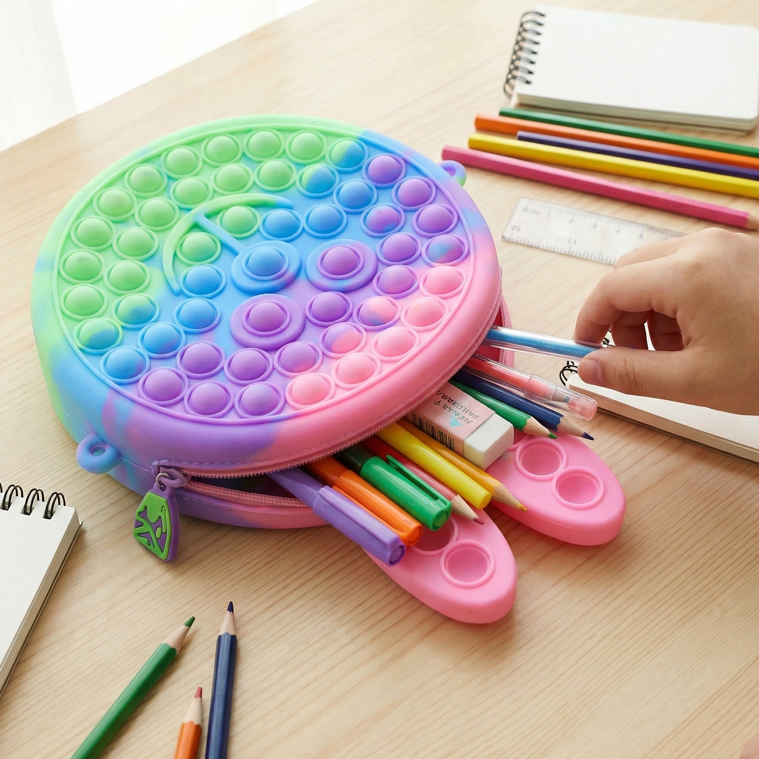Cute caterpillar-shaped silicone pencil pouch by Wukusy, featuring pop it bubbles, ideal for school supplies and organization.