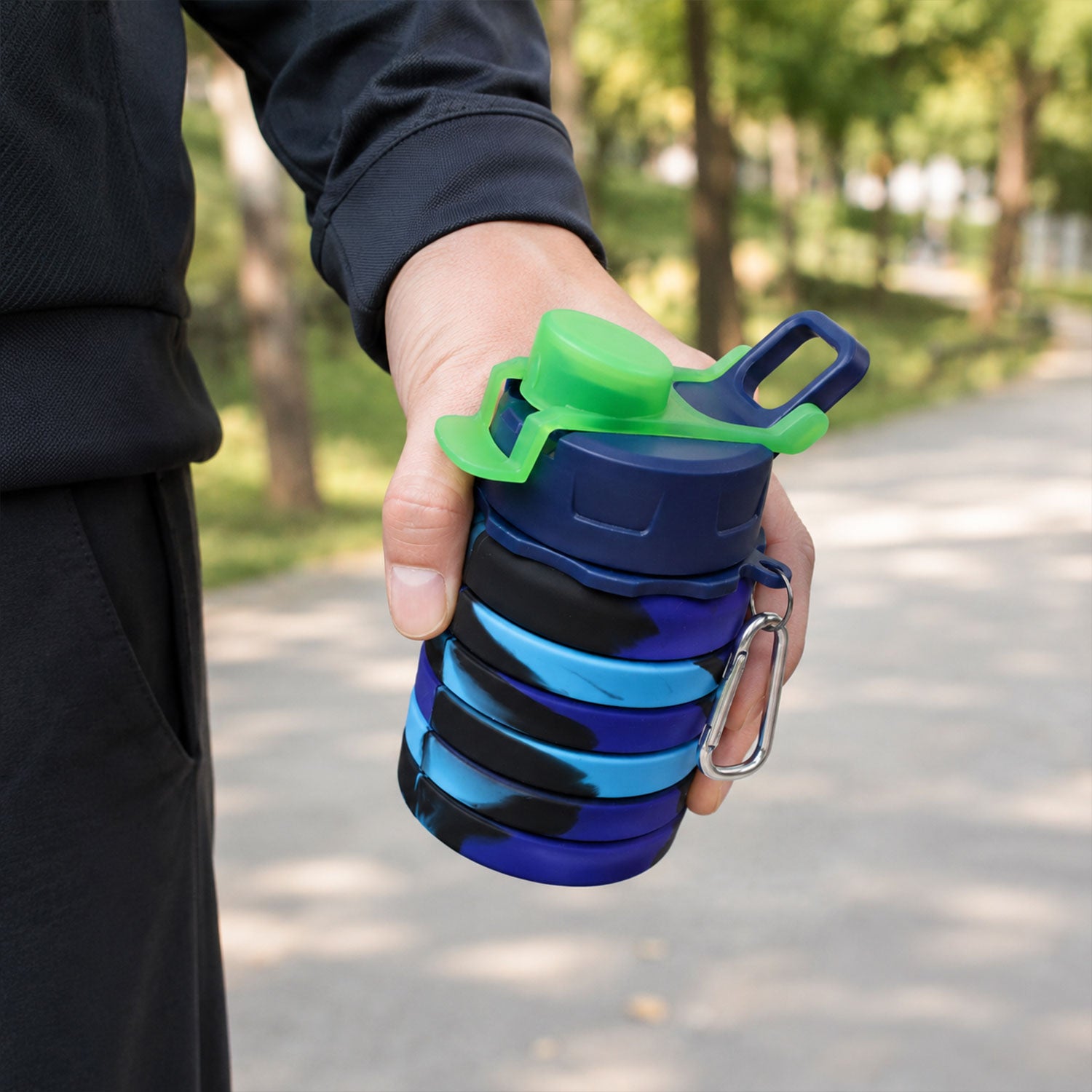 Wukusy Sili Fold collapsible silicone water bottle, 500ml, leakproof with carabiner, shown folded and expanded for travel.