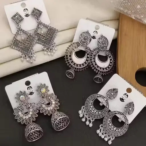 Set of 4 oxidized silver earrings including jhumki and hoop styles by Ekom, featuring traditional and modern jewelry for women and girls.