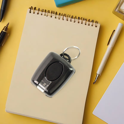 Wukusy mini LED torch keychain showing compact black design with attached keyring and LED light on the front.