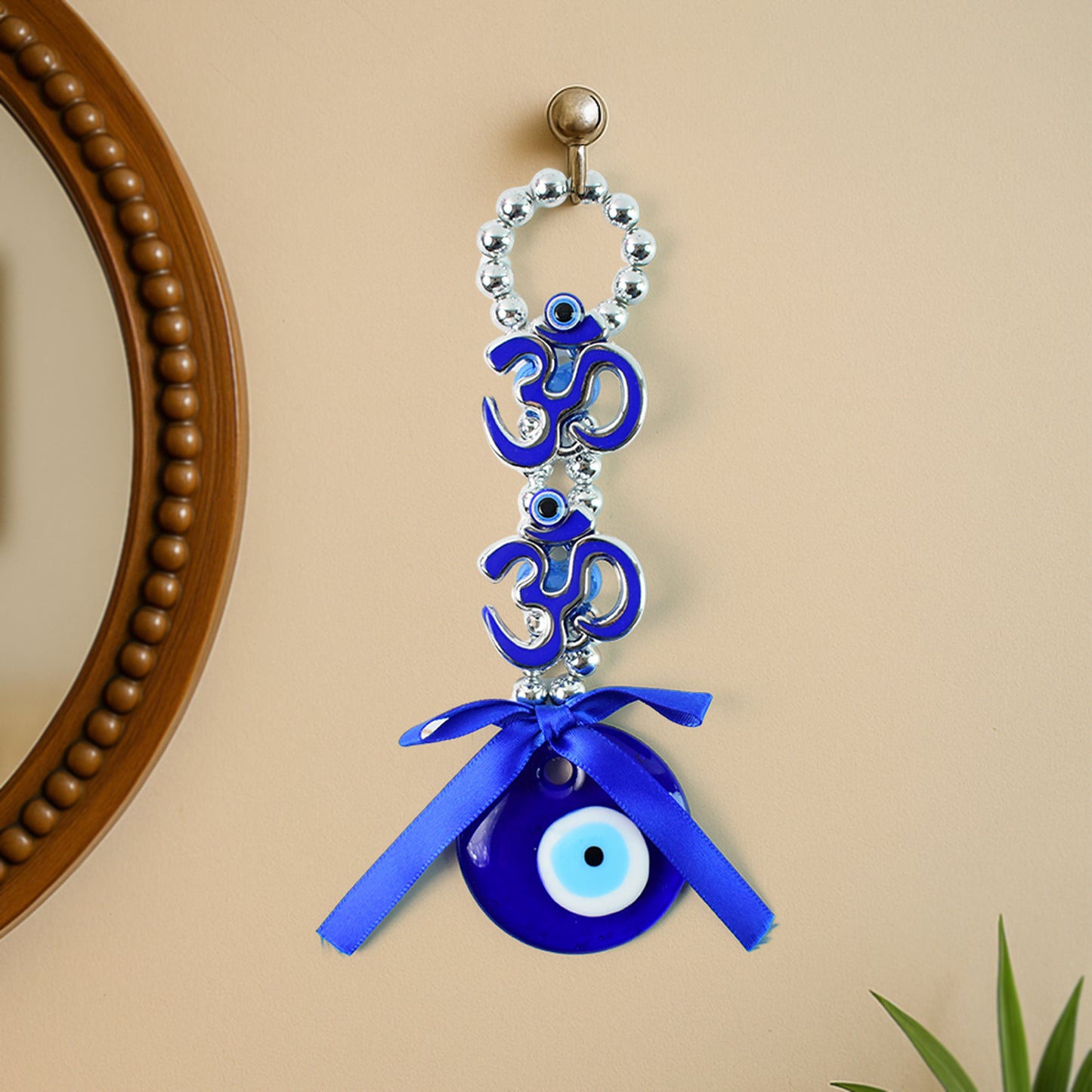 Decorative double Om symbol evil eye hanging ornament by Wukusy, featuring intricate design and vibrant colors on a white background.