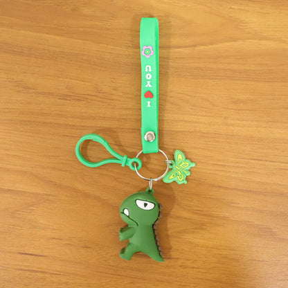 Cute dinosaur cartoon keychain with silicone strap from Wukusy, featuring a colorful, playful dinosaur design on a durable keyring.