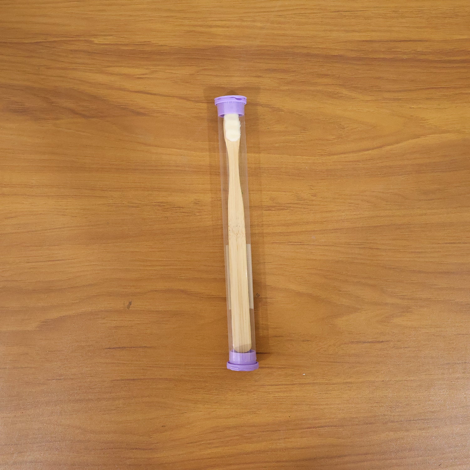 Eco-friendly wooden bamboo toothbrush with protective travel case by Wukusy, shown with natural bamboo handle and travel cover.