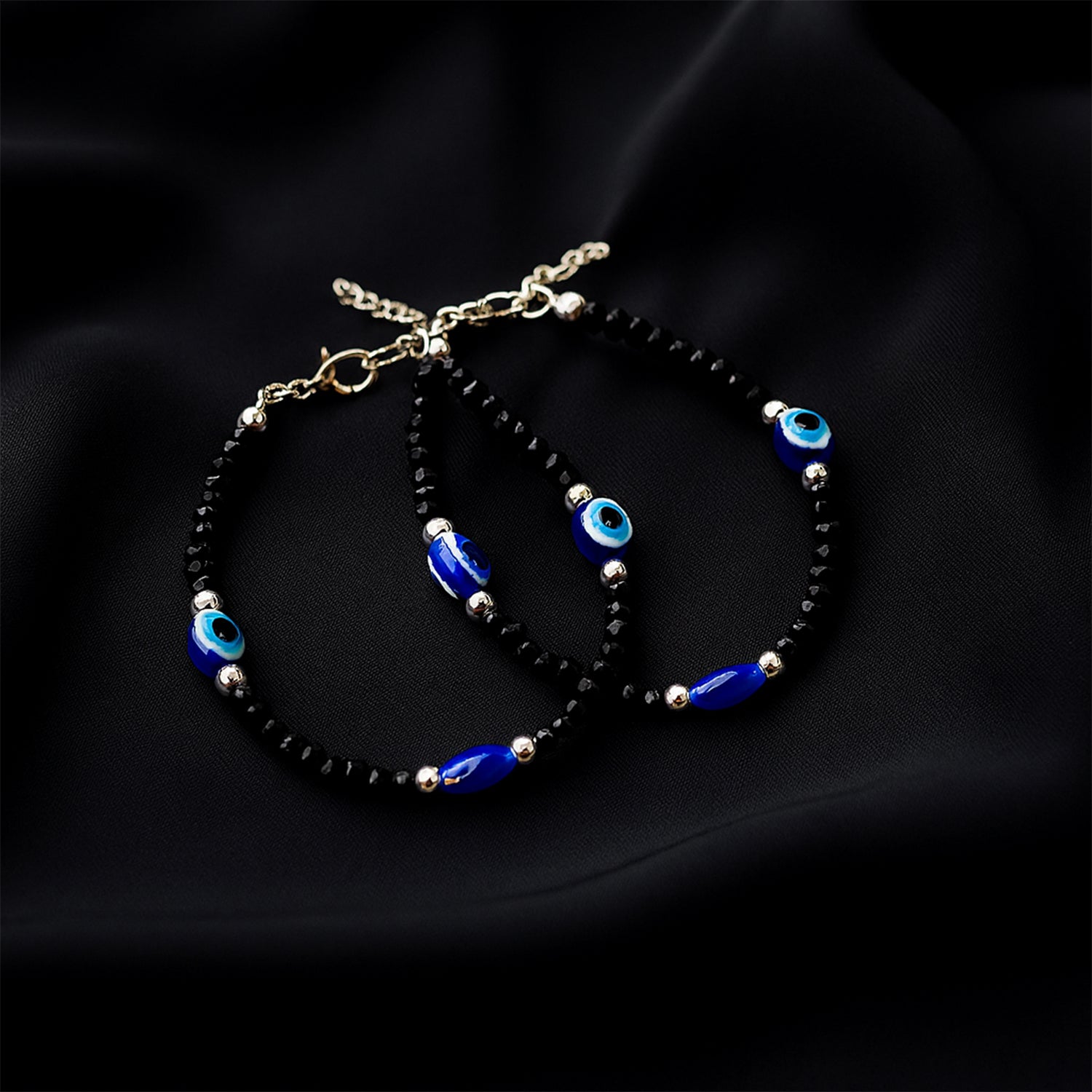 Adjustable black bead evil eye protection bracelet set by Wukusy with two stylish beaded bracelets featuring eye charms.