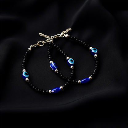 Adjustable black bead evil eye protection bracelet set by Wukusy with two stylish beaded bracelets featuring eye charms.
