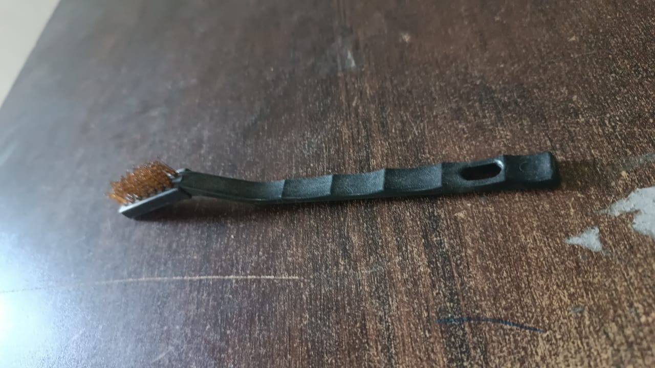 Wukusy mini brass wire brush with sturdy handle, ideal for cleaning and detailing small metal surfaces and tools.
