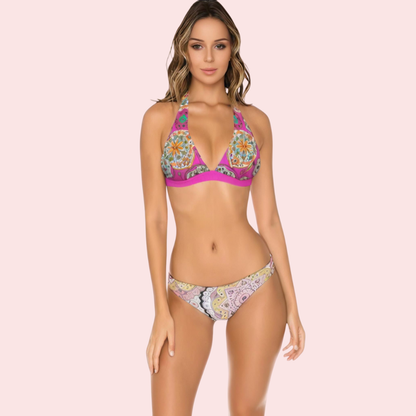 Pink geometric mandala halter bikini top by Snazzyway with adjustable straps and vibrant pattern, shown on a flat surface.