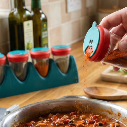 Wukusy 4-in-1 multipurpose spice shaker set with four compartments and clear lids, ideal for storing and seasoning spices.